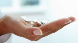 womans hand with coins