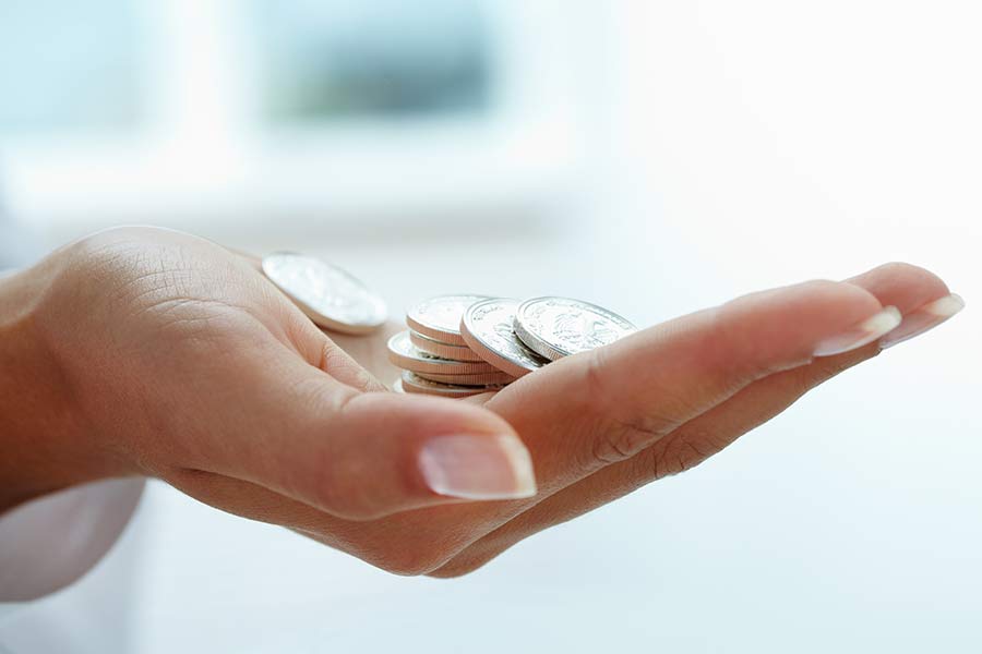 womans hand with coins