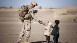 soldier helping kids
