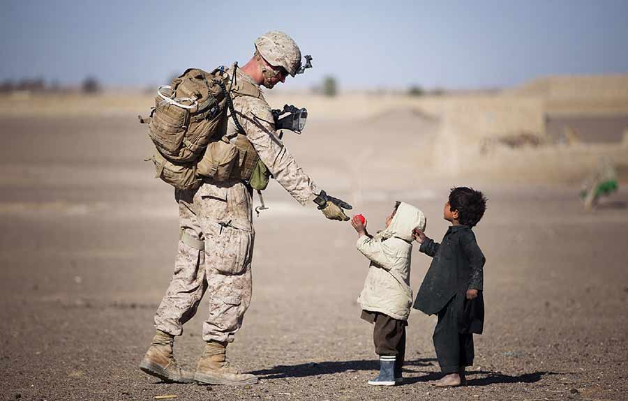 soldier helping kids