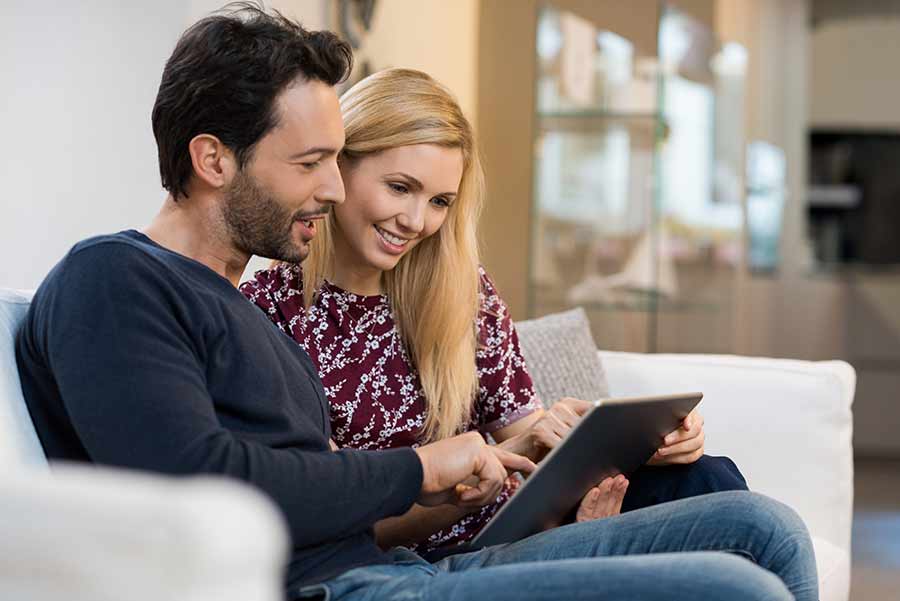 couple doing taxes on laptop